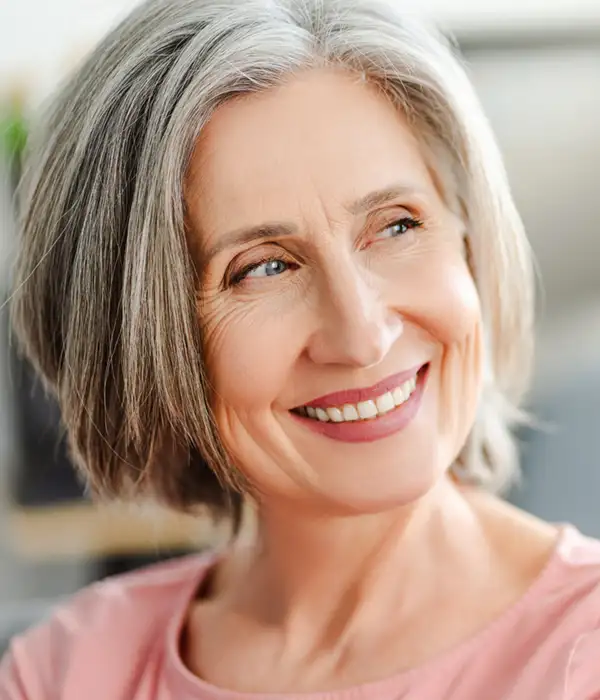 senior woman smiling and looking off to the right