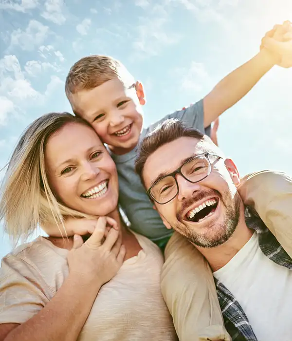 mother, father, and son smiling and laughing